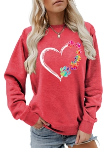 Detailed close-up of ribbed cuffs and vibrant heart-paw print on a red sweatshirt