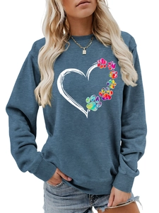 Detailed close-up of heart print with rainbow tie-dye paw patterns on blue sweatshirt