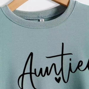 Mint green crewneck sweatshirt for women featuring black Auntie text and heart print
