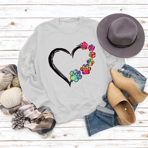 Flat lay of gray sweatshirt with rainbow paw heart print and autumn accessories