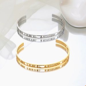 Minimalist C-shaped open cuff bracelets in gold and silver with engraved lettering