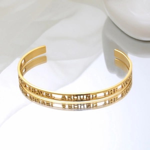 Minimalist gold C-shaped open cuff bracelet with engraved hollow travel slogan