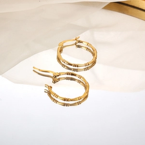 Golden bamboo textured hoop earrings for women with polished metallic finish