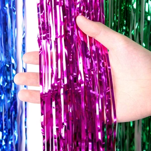 Close-up of shiny blue, pink and green metallic foil tinsel curtains for party decor