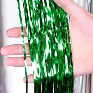Detail of green metallic foil fringe curtain showing reflective texture for party decor