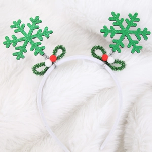 Christmas headband with green glitter snowflakes and red berries on a white faux fur backdrop