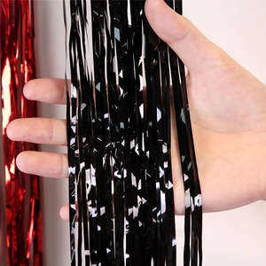 Close-up of shiny black and red metallic tinsel fringe curtains for Christmas DIY decoration