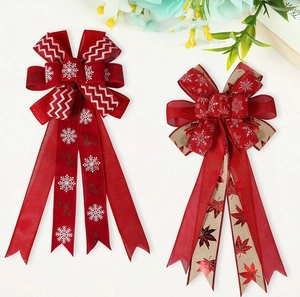 Detail of red snowflake elk ribbon and burlap maple leaf bows for Christmas decor