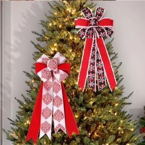 Detail of festive double-layer Christmas bows featuring red patterns and plaid on a tree