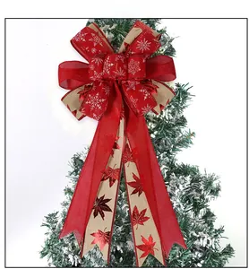 Close-up of rustic burlap Christmas bow with snowflake patterns on a snow-covered tree