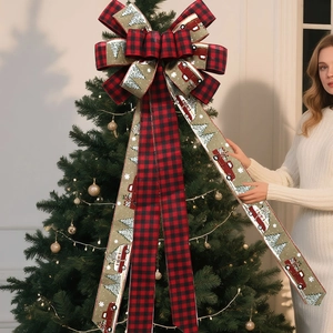 Detail of red and black buffalo plaid Christmas tree topper bow with vintage truck pattern
