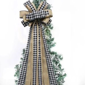Detail of buffalo plaid Christmas tree topper bow with rustic burlap ribbons and long tails