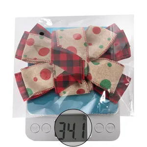 Detail showing the 34.1g weight of the plaid burlap Christmas bow on an electronic scale