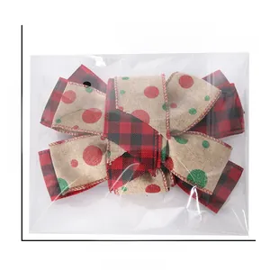 Close-up of red and black plaid Christmas bow decoration with glitter dots in clear packaging