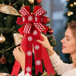 Red Christmas tree topper bow with white snowflakes and reindeer patterns decoration