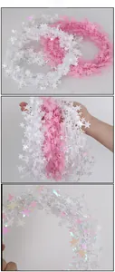 Detail of shimmering pink and iridescent star-shaped wire garland for Christmas decor