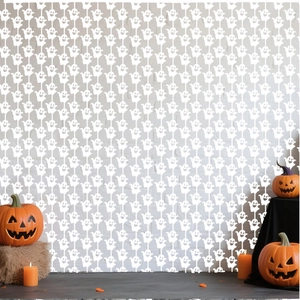 Detail of Halloween white ghost fringe curtain backdrop with pumpkin and candle props