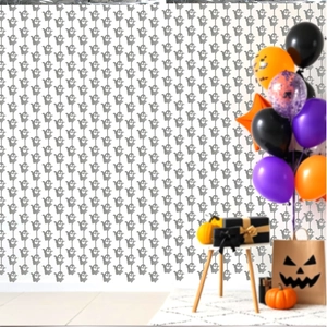 Detail view of silver ghost garland streamers with pumpkin and balloon party decorations