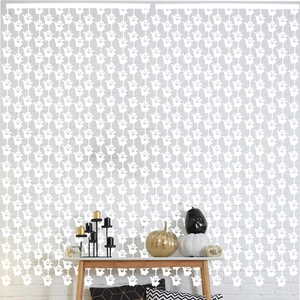 White ghost fringe curtain for Halloween party decor with small ghosts hanging in rows