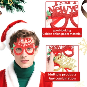 Detail of glitter Happy New Year glasses with festive red berries and snowflakes motifs