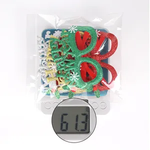 Detailed view of Christmas glasses set being weighed at 61.3g on a digital scale