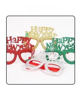 Close-up of Happy New Year glasses in gold, red, green, and silver glitter finishes