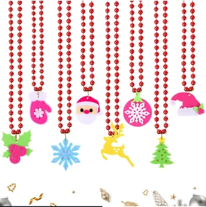Close-up of assorted Christmas felt pendants with red plastic bead chains for party decor