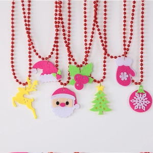 Detailed view of colorful felt Christmas ornaments on red beaded festive necklaces