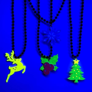 Macro shot of glow in the dark Christmas charms including reindeer and snowflake pendants