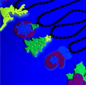 Detailed view of colorful felt Christmas pendants like reindeer and snowflakes on bead chains