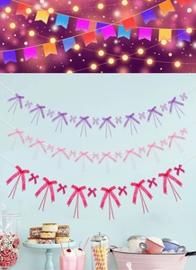 Detail of hanging heart mesh bow streamers in red, pink and purple for party decor