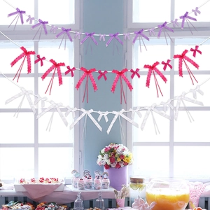 Close-up of decorative purple and white polyester ribbon bows for party hanging decor