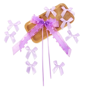 Close-up of purple heart mesh organza and satin ribbon bows for DIY gift packaging