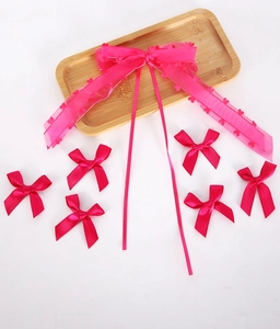 Detail of fuchsia coquette bow set with organza heart patterns and satin textures