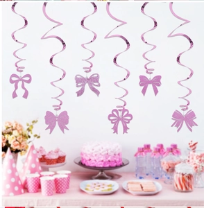 Macro detail of six pink glitter bow spiral ceiling swirls for birthday party decor