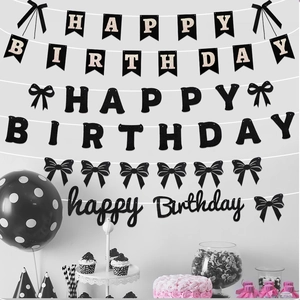 Detailed view of black and pink Happy Birthday banners with elegant bow decorations