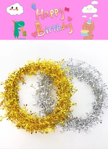 Close-up of sparkling gold and silver star tinsel garlands for Christmas tree decoration