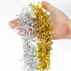 Close-up of sparkling gold and silver Christmas star tinsel wire garland for party decor