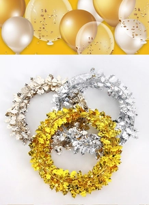 Close-up of metallic gold and silver berry leaf tinsel garlands for festive party decor