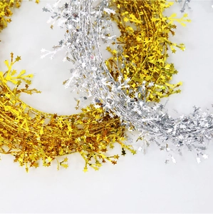 Close-up of gold and silver tinsel garland with wire stars for Christmas decoration