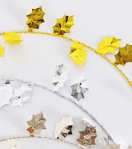 Detailed view of gold and silver metallic holly leaf garlands for Christmas DIY decoration
