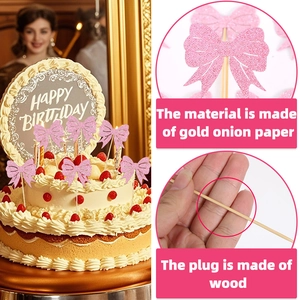 Close-up of pink glitter bow cake toppers with wooden sticks for birthday party decor