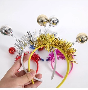 Close-up of colorful disco ball headbands with metallic tinsel for party costumes