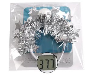 Detailed view of silver sequin star headband on a digital scale weighing 37.7g