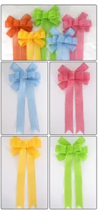 Close-up of colorful faux linen Christmas bows with mesh texture and swallowtail ribbons