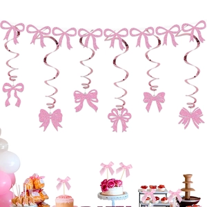 Close-up of pink glitter bow hanging swirls and matching cupcake toppers for party decor