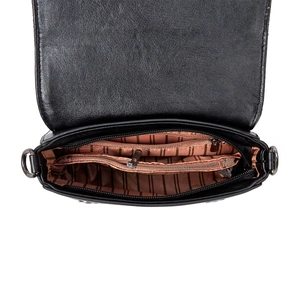 Detail view of the soft black leather crossbody bag featuring multiple interior zip pockets
