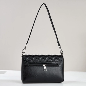Rear view of black quilted crossbody bag showing smooth leather and zipper pocket