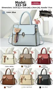Detailed view showing bag dimensions 32x13x24cm with bear charm and interior structure