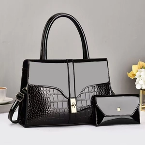 Black crocodile-pattern patent leather tote set with gold twist lock and shoulder strap